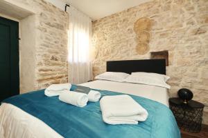 a bedroom with a bed with towels on it at Vacation House Meri in Blato +46 photos