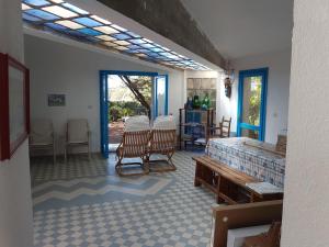 a room with a bed and chairs in it at Beachfront villa, right ON SAND! in Cala Liberotto