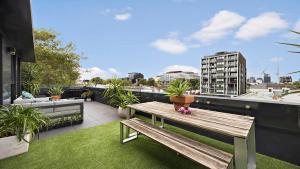 a wooden bench sitting on top of a balcony at Richmond Retreat in Melbourne +4 photos