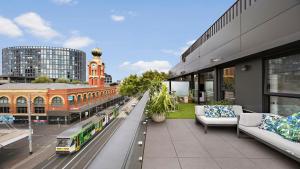 a balcony of a building with a bus on the street at Richmond Retreat in Melbourne