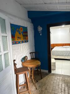 a room with a table and a bed and a bedroom at Villa Buziana 1 in Búzios