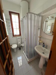 a bathroom with a shower and a toilet and a sink at Oasi Palma - Mondello in Palermo +36 photos