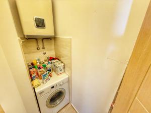 a small bathroom with a washing machine and a washer at Jelena apart Budva in Becici