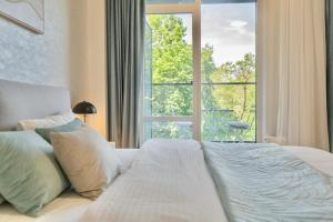 a bedroom with a bed with a large window at City Rooms Greenwood in Odesa +13 photos