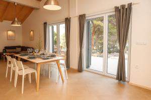 a dining room with a table and chairs and a window at Salum in Trogir