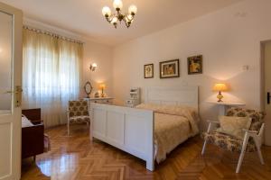 a bedroom with a bed and a desk and a chair at Apartments Coce in Trogir