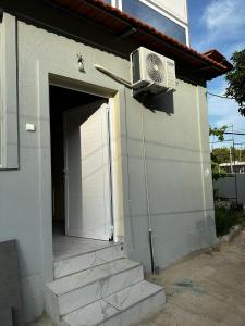 a door to a house with a fan on the side at Holiday Home in Polisi i Vogël +5 photos