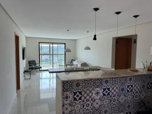 a kitchen and living room with a counter in a room at Alto da Serra Villas - Flat 301 in Bananeiras