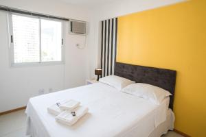 En eller flere senge i et værelse på Apartamento Luxo Barra + 33 billeder