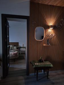 a room with a table and a mirror and a bedroom at Galamus Bonheur - Quand tu veux t'échapper de chez toi ! in Saint-Paul-de-Fenouillet