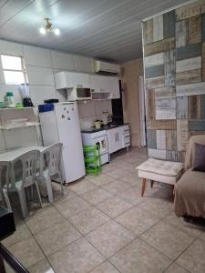 a kitchen with a refrigerator and a table and chairs at FLAT CENTRAL- Ar-Condicionado-Estacionamento in Feira de Santana