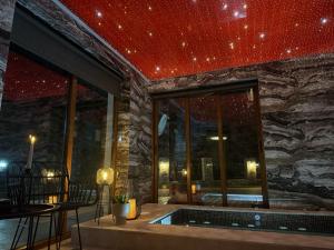 a room with a hot tub in a stone wall at Планинска вила АЛТЕА in Mostowo