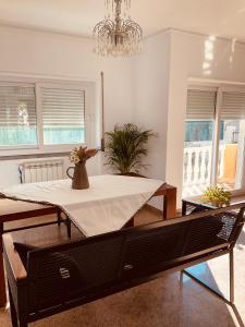 a dining room with a table with a vase on it at Villa jardins Da Paz in São Domingos de Rana +60 photos