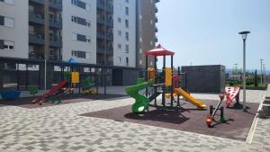 a playground with a slide in a courtyard at BrandNew Apartment in Podgorica