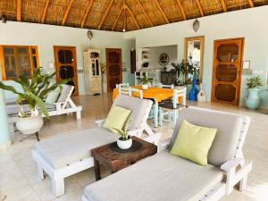 a living room with a couch and a table at Casa Punta Perula Boutique Hotel in Pérula