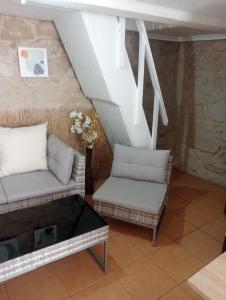 a living room with two chairs and a table at La Casita in Cangas de Morrazo +13 photos