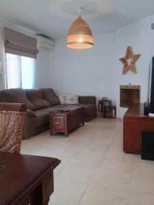 a living room with a couch and a table at Family Vacation in Málaga