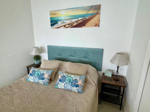 a bed with two pillows on it in a bedroom at Appartement 4 pers Front de Mer - 10m de la Plage in Saint-Raphaël