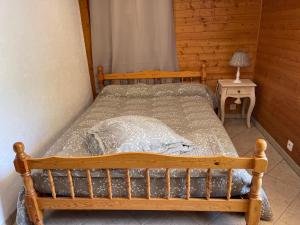 a bedroom with a wooden bed in a room at la terrasse in Saint-Étienne-de-Tinée