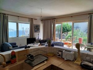 a living room with a couch and a table at Open view 1 in Límni
