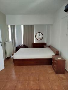 a bedroom with a large bed and a mirror at Open view 1 in Límni