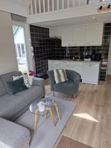 a living room with a couch and a table at Heerlijk ! in Simpelveld