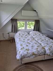 a bedroom with a large bed in a attic at Heerlijk ! in Simpelveld +5 photos