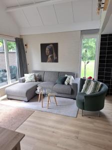 a living room with a couch and a chair at Heerlijk ! in Simpelveld