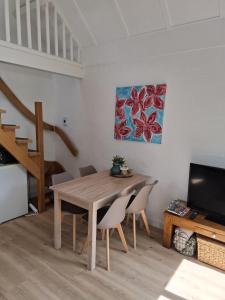 a dining room with a wooden table and chairs at Heerlijk ! in Simpelveld