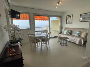 a living room with a couch and a table at Appartement 4 pers Front de Mer - 10m de la Plage in Saint-Raphaël