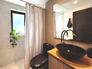 a bathroom with a black sink and a shower at Garden House Las Condes in Santiago +17 photos