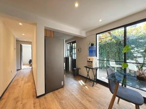a room with a glass table and a dining room at Garden House Las Condes in Santiago