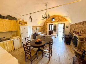 a kitchen and living room with a table and chairs at One&Only Kalamoti Gem Retreat in Kalamoti