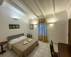 a bedroom with a bed with two stuffed animals on it at One&Only Kalamoti Gem Retreat in Kalamoti