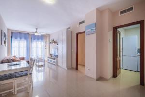 a kitchen and living room with a white refrigerator at Apartamento Vista Azul in Costa Ballena