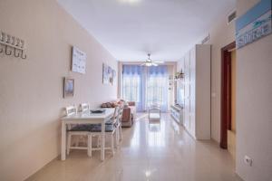 a living room with a table and a couch at Apartamento Vista Azul in Costa Ballena
