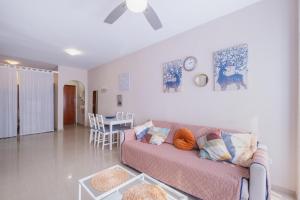 a living room with a couch and a table at Apartamento Vista Azul in Costa Ballena +17 photos