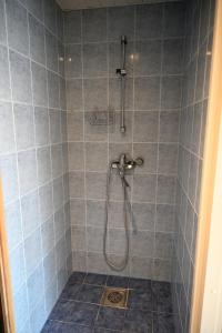a bathroom with a shower with blue tiles at 2-Story Penthouse with Private Sauna, Seaview Terrace & Two Bathrooms in Tallinn