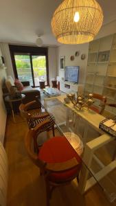 a living room with a glass table and chairs at Pombal Bayona in Baiona