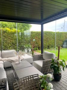 a patio with white furniture and a large window at Willa Atena in Łeba +58 photos