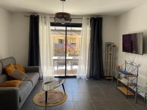a living room with a couch and a table at mini villa duplex Bonifacio 70m2 in Bonifacio