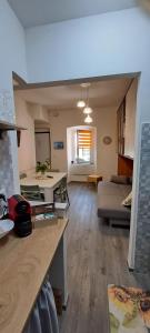 a kitchen and living room with a couch and a table at La Casetta al Poggio in Valentano