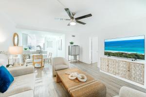 a living room with a couch and a table at Coastal Escape Walk to Beach Pool and Gym in Boca Raton