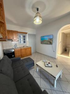a living room with a couch and a table at Coral Nest in Logaras