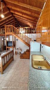 a kitchen with a sink and a staircase in a room at Christina house in Sikia