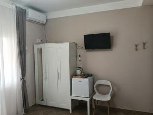 a room with a white cabinet and a chair at civico 250 in Pescara