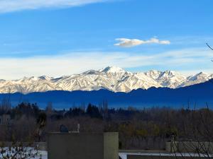 a view of snow covered mountains in the distance at Chacras de Coria Los Robles in Chacras de Coria