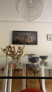 a glass dining room table with a antler on it at Pombal Bayona in Baiona +40 photos