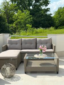 a patio with a couch and a glass table at Apartman Perla in Gornji Kraj +40 photos