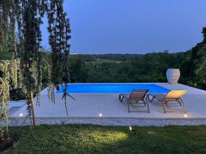 a patio with two chairs and a swimming pool at Apartman Perla in Gornji Kraj